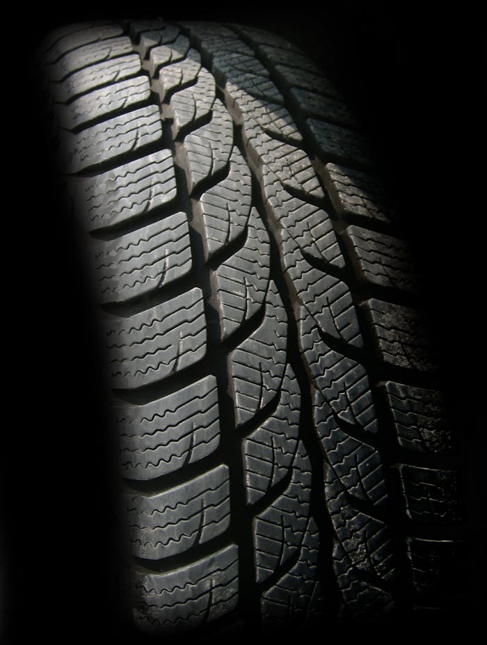 about-us-02 Detailed close-up image of a rubber tire showcasing texture and tread pattern, ideal for design concepts.